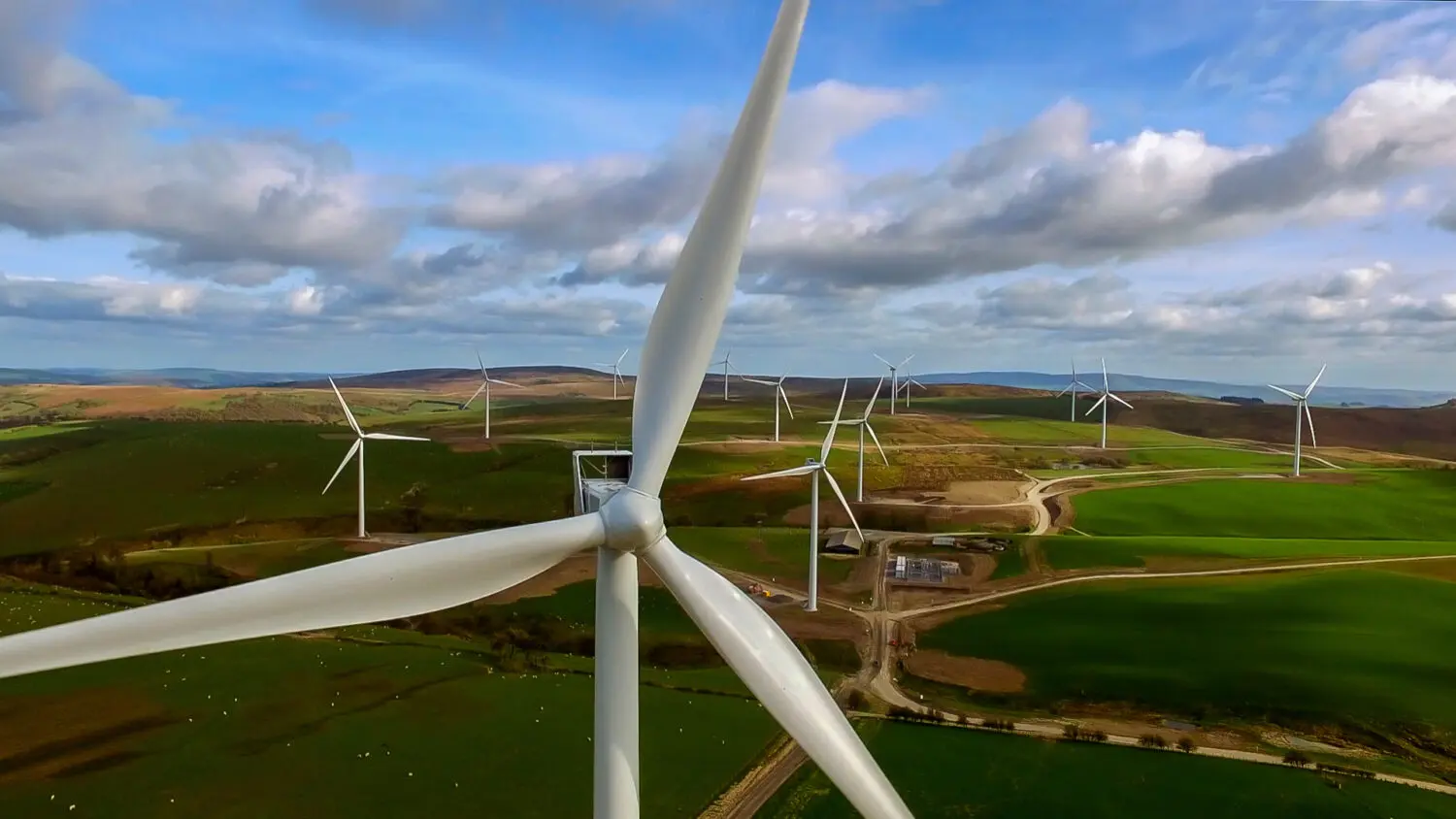 Close up wind turbine with other turbines in distance