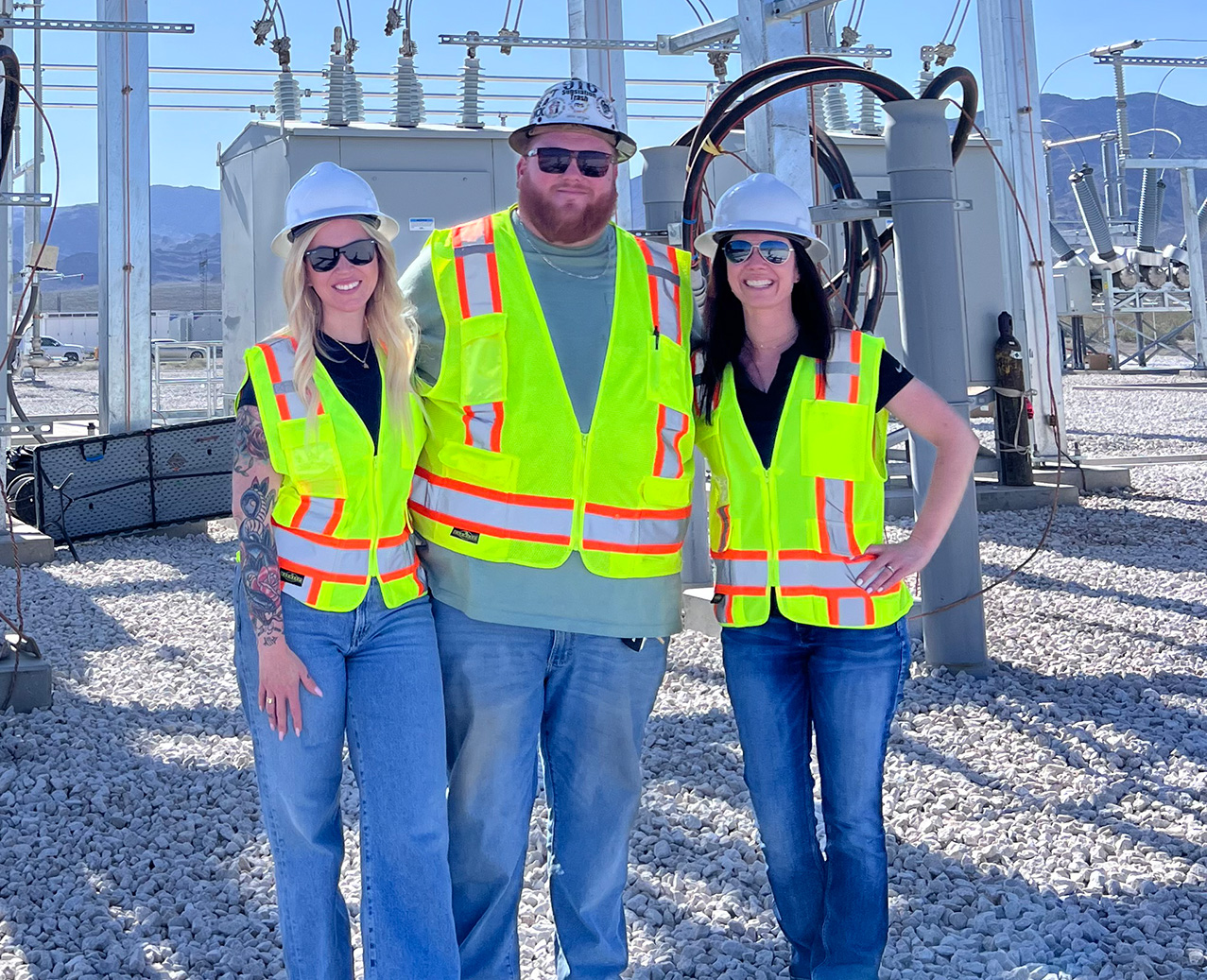 People in PPC in front of electricity infastructure