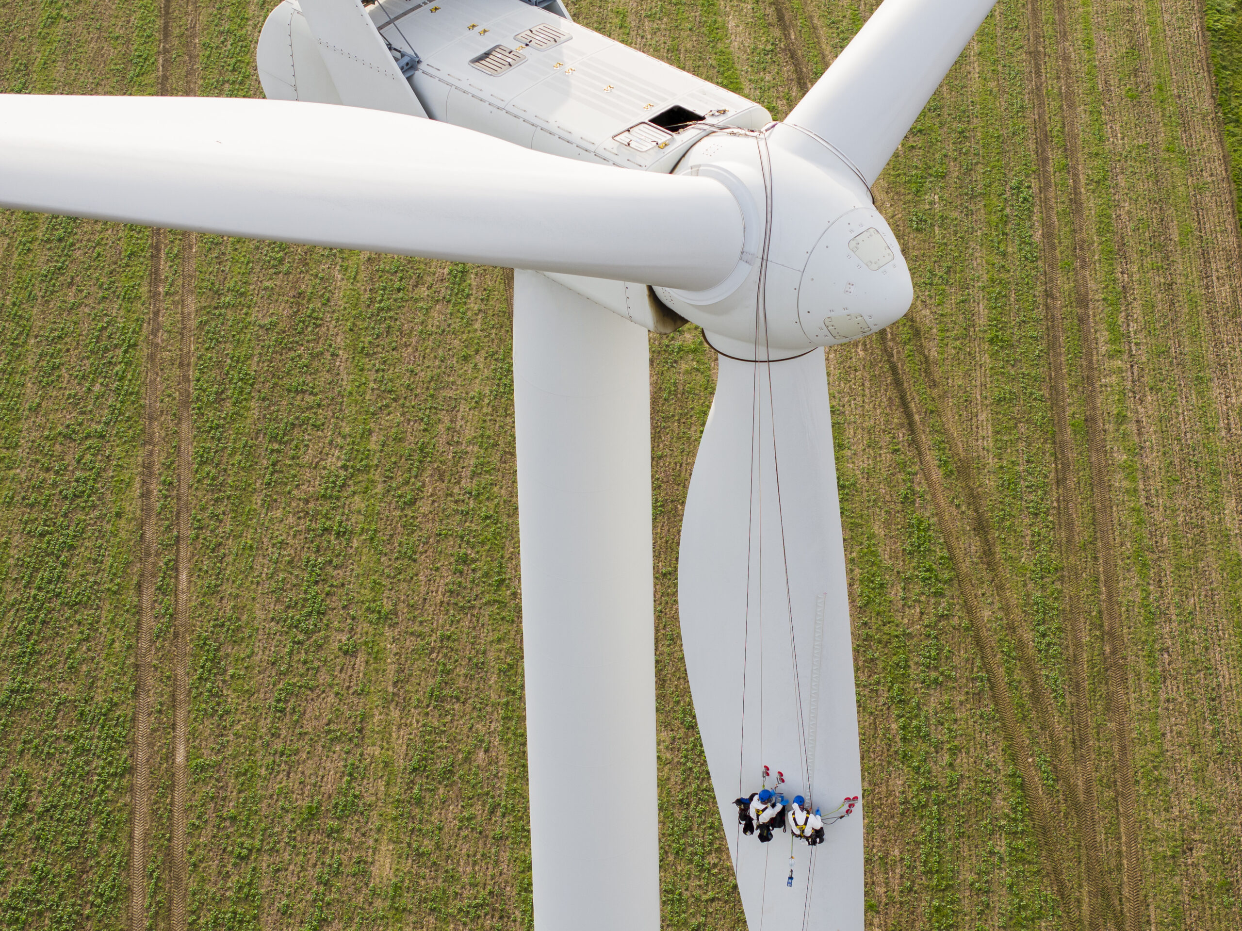 people working on a wind turbine blade